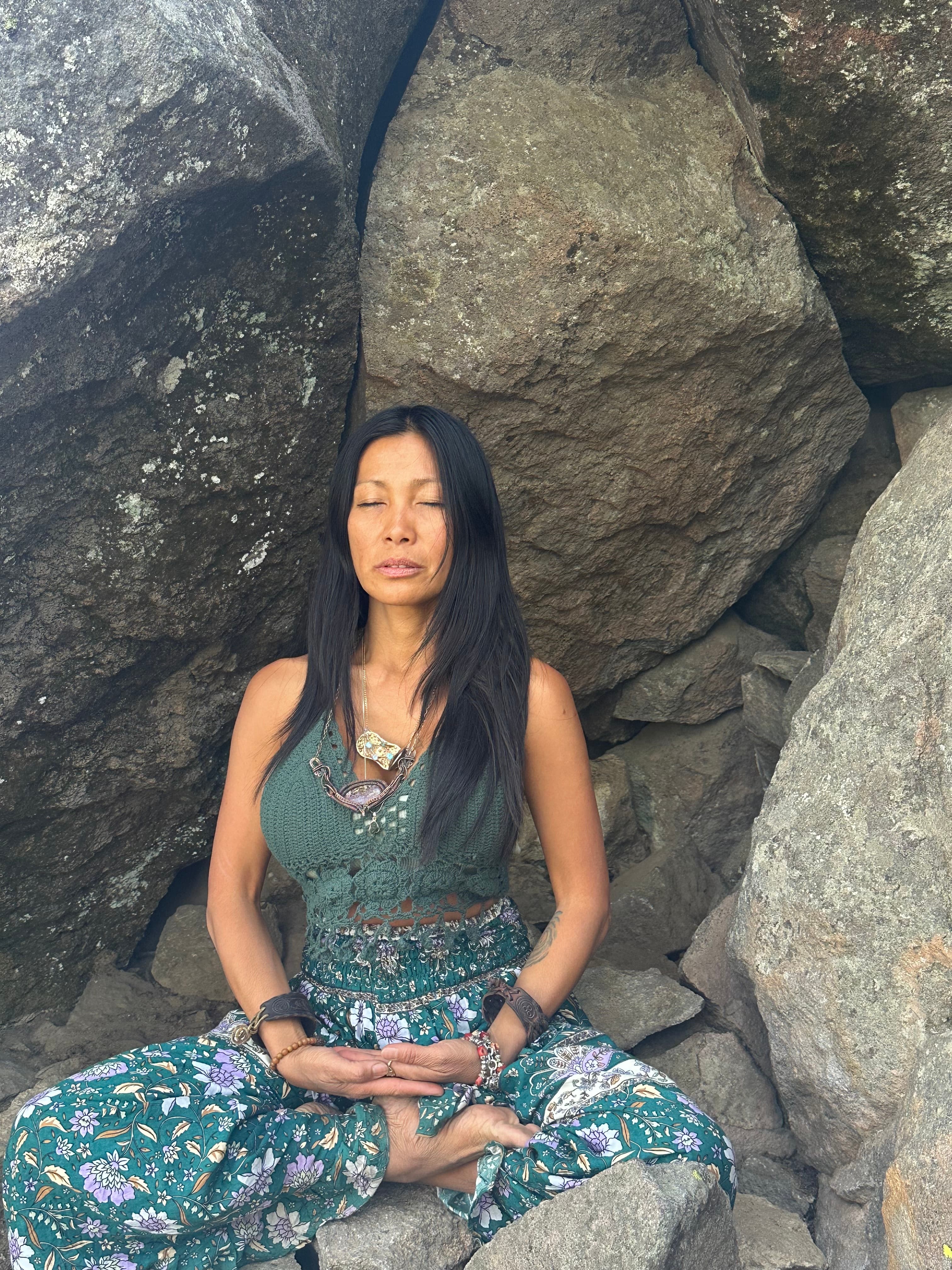 Master Kwasha in meditation among coastal rocks